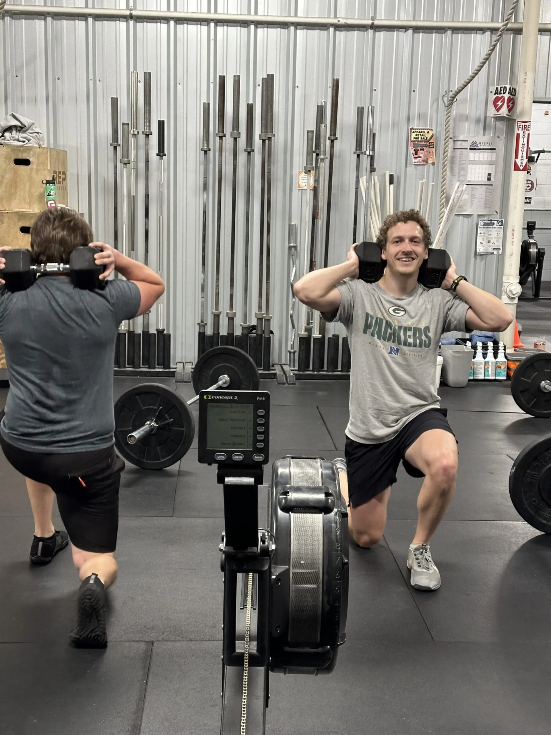 A member pulling a barbell into a clean at Cream City CrossFit.